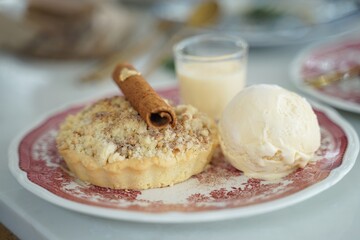 Delicious Crumble Tart Served with a Scoop of Vanilla Ice Cream and Eggnog