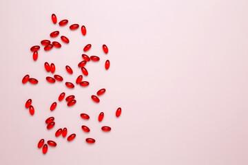 Red pills and capsules scattered. Concept of medicine, healthcare, and pharmaceutical industry