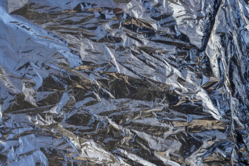 Black crumpled plastic bag close-up.