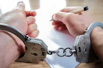 Handcuffed, they write on paper, expressing their innermost thoughts despite their restrictions