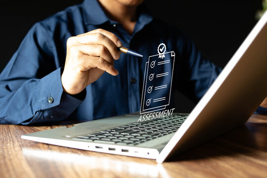 Concept of assessment analysis, measurement technology, businessman, using laptop to evaluate business performance, data analysis, strategic planning, showing document icon on virtual screen.
