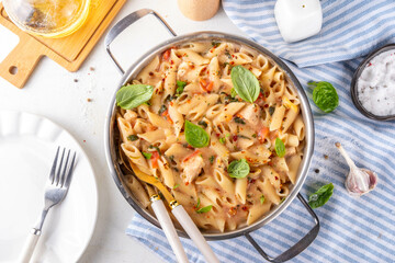 Trendy viral marry me chicken pasta. One pot balanced tender cooked pasta and juicy chicken pieces smothered in creamy and cheesy, garlic sun-dried tomato sauce, wit basil leaves, in plate and pot