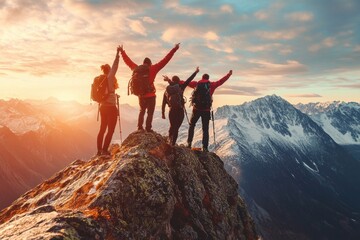 Happy hikers celebrating adventure on mountain peak at sunrise