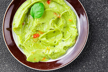 Guacamole dip avocado sauce cold appetizer vegetable dish organic product fresh tasty gourmet food background on the table rustic food top view copy space 