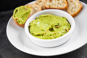 Guacamole dip avocado sauce cold appetizer vegetable dish organic product fresh tasty gourmet food background on the table rustic food top view copy space 