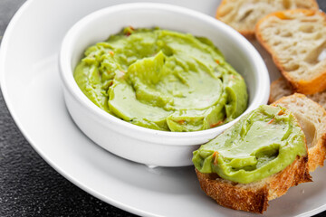 Guacamole dip avocado sauce cold appetizer vegetable dish organic product fresh tasty gourmet food background on the table rustic food top view copy space 
