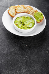 Guacamole dip avocado sauce cold appetizer vegetable dish organic product fresh tasty gourmet food background on the table rustic food top view copy space 