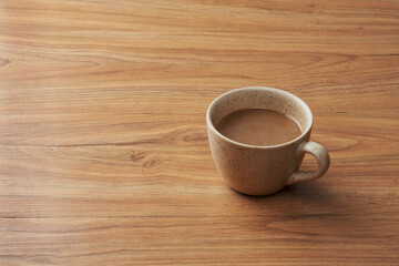 a glass of mixed coffee served on a wooden table   