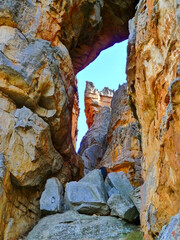 Narrow gorge with loose rocks and overhanging rocks part of The cracks hiking trail in the Cederberg Mountain range.