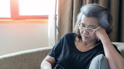 Menopause woman with anxiety disorder, mental health illness, stressful depressed aging businesswoman female person with headache and migraine sitting tiredly at home