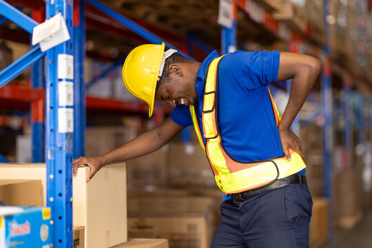 worker back pain, african male worker working in warehouse storage suffering from muscle problem