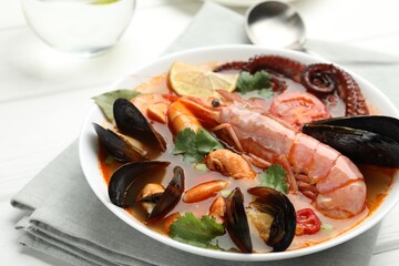 Delicious seafood soup in bowl on table, closeup