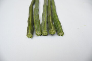 Moringa oleifera or drumstick pods on white background. This is a Moringaceae family tree. Its other names  moringa, horseradish, and ben oil tree and benzolive. It is a popular vegetable. 