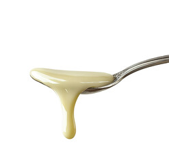 Sour cream in a spoon on a  Creamy white substance spills from a silver spoon onto a light gray  white background 

