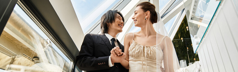 Radiant couple shares a joyful moment during their beautiful wedding ceremony under a sunny sky