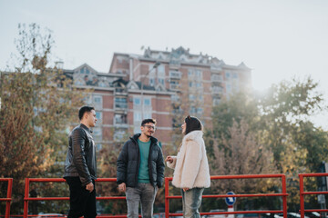 A group of three friends engages in a lively conversation outdoors, surrounded by urban buildings...