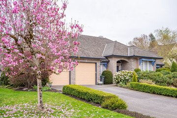 Garage door in luxury house with trees and nice landscape in Spring in Vancouver, Canada, North...