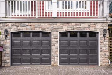 Garage door in luxury house with trees and nice landscape in Spring in Vancouver, Canada, North...