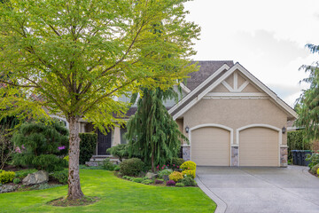 Garage door in luxury house with trees and nice landscape in Spring in Vancouver, Canada, North...