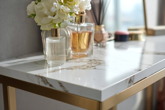 Gold-framed vanity table with marble-look top and decorative items.