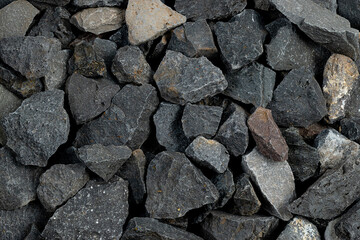 Volcanic basalt stone surface with rough texture, captured close-up