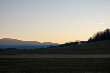 Sunrise mist over rural hills and fields