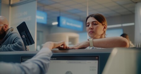 Airport Check-in Counter: Passenger Doing Fingerprint Scanning. Female Airline Worker Checking...