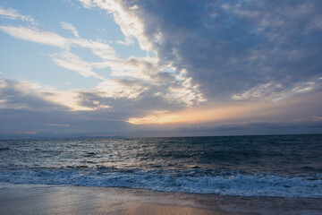 The sky is blue and the sun is setting.