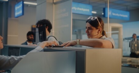 Queue of Multiethnic Passengers at Airport Check-in Counter: Female Airline Worker Checking...