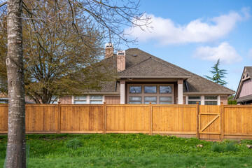 Fence built from wood in Vancouver, Canada, North America. Outdoor landscape. Security and privacy concept. Day time on April 2025.