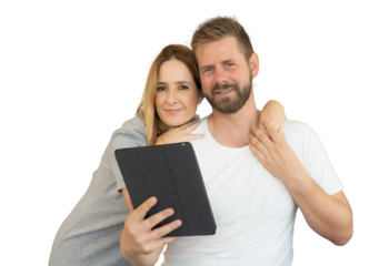 Close-up of a happy loving young couple together holding a tablet.