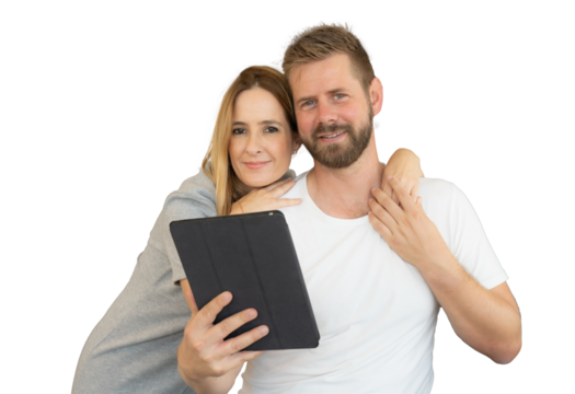Close-up of a happy loving young couple together holding a tablet.