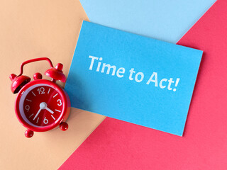 Red alarm clock and blue card with text Time to Act! on colorful background, symbolizing urgency...
