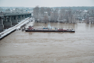 A large boat is gently floating on the surface of a vast and expansive body of water, creating a...