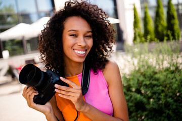 Photo of attractive young cheerful lady cute photographer wear colorful garment spend time enjoy...