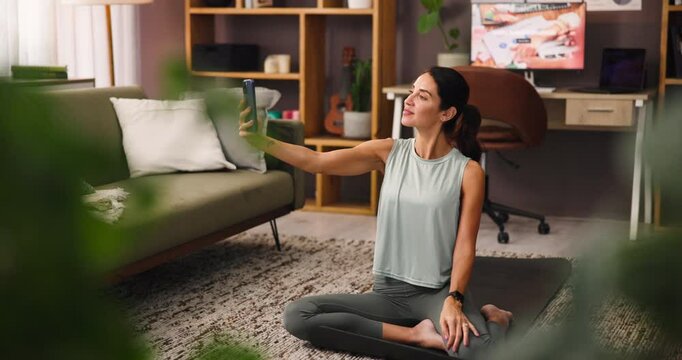 Selfie, workout and woman with smile, lounge and post of exercise routine on web, laughing and home. Happy, fitness and mature person with app for social media, healthy and picture of influencer