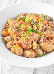 Baked baby potatoes with crispy bacon, melted cheddar, and fresh green onion