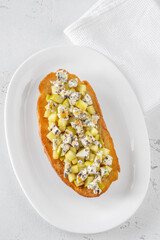 Toasted sandwich with blue cheese, honeyed sauteed apple on minimalist white plate