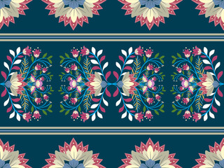 A decorative floral pattern featuring vibrant colors on a dark background, showcasing a symmetrical design of flowers and greenery.