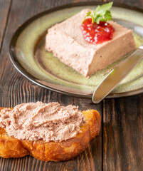 Goose liver pate served with toasted bread, cranberry jam, and pickles