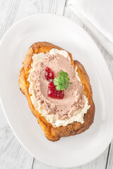 Gourmet sandwich layered with pate, cranberry jam, and cream cheese
