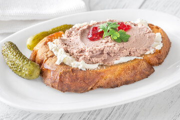 Gourmet sandwich layered with pate, cranberry jam, and cream cheese