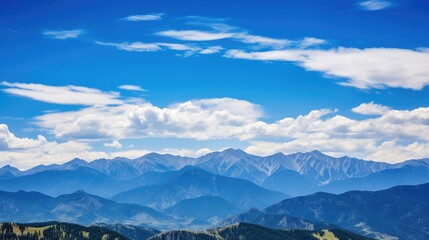 peaks blue sky fluffy clouds