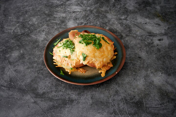 A plate of food with two pieces of food on it. The plate is blue and the food is cheesy