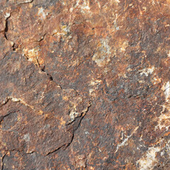 Natural rock formation displaying intricate textures and earthy colors background.