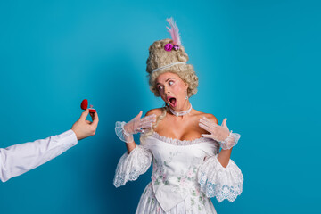 Surprised woman in baroque costume reacts to a modern marriage proposal with a ring, combining historical elegance and contemporary themes