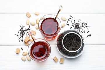 Obraz na płótnie Canvas Tasty Turkish tea, sugar and pistachios on white wooden table, flat lay