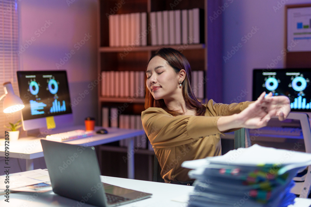 Poster office worker relaxing and stretching arms after long hours at the computer, finding a moment of cal