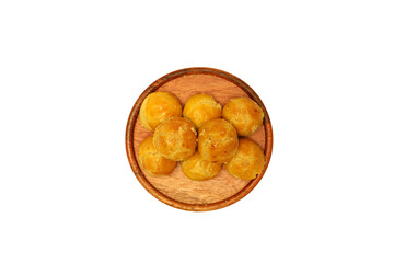 Nastar cookies with topping Egg yolk spread, served on wooden plate for Idul Fitri, Moselm Feast day. Traditional Cake in Indonesia Nastar Cake. Isolated on white background