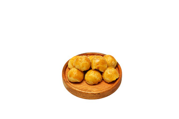 Nastar cookies with topping Egg yolk spread, served on wooden plate for Idul Fitri, Moselm Feast day. Traditional Cake in Indonesia Nastar Cake. Isolated on white background
